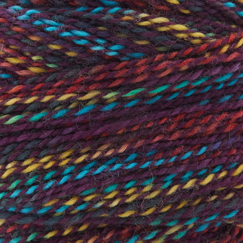 Cobblestone Superwash Merino Wool in Mardi Gras — purple, red, yellow, turquoise, and blue variegated, 612‑yard skein